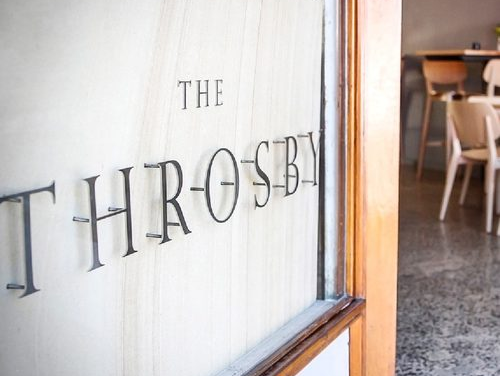 A close up of a sign on a door that says `` the throb ''.