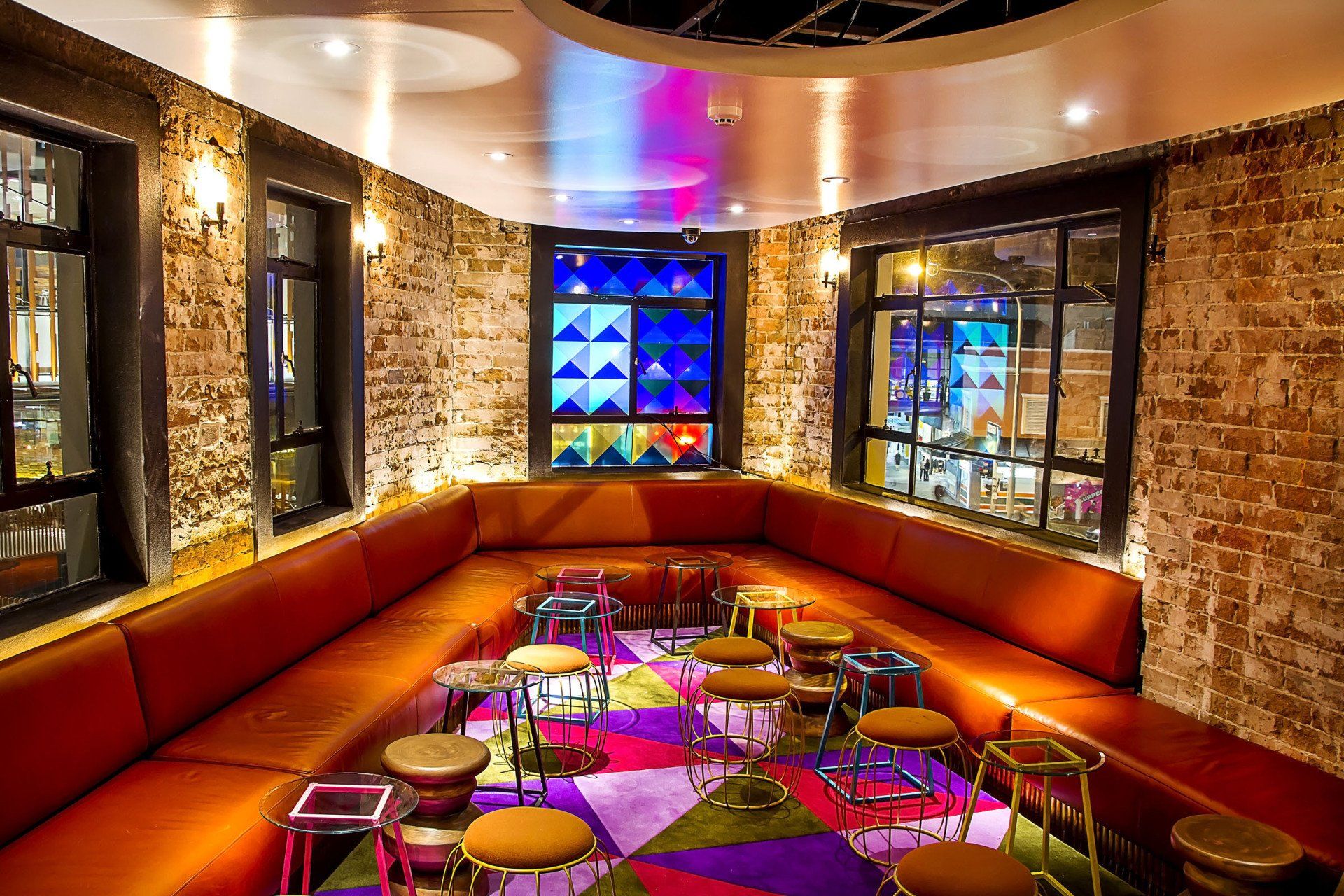 A large room with a lot of furniture and a stained glass window