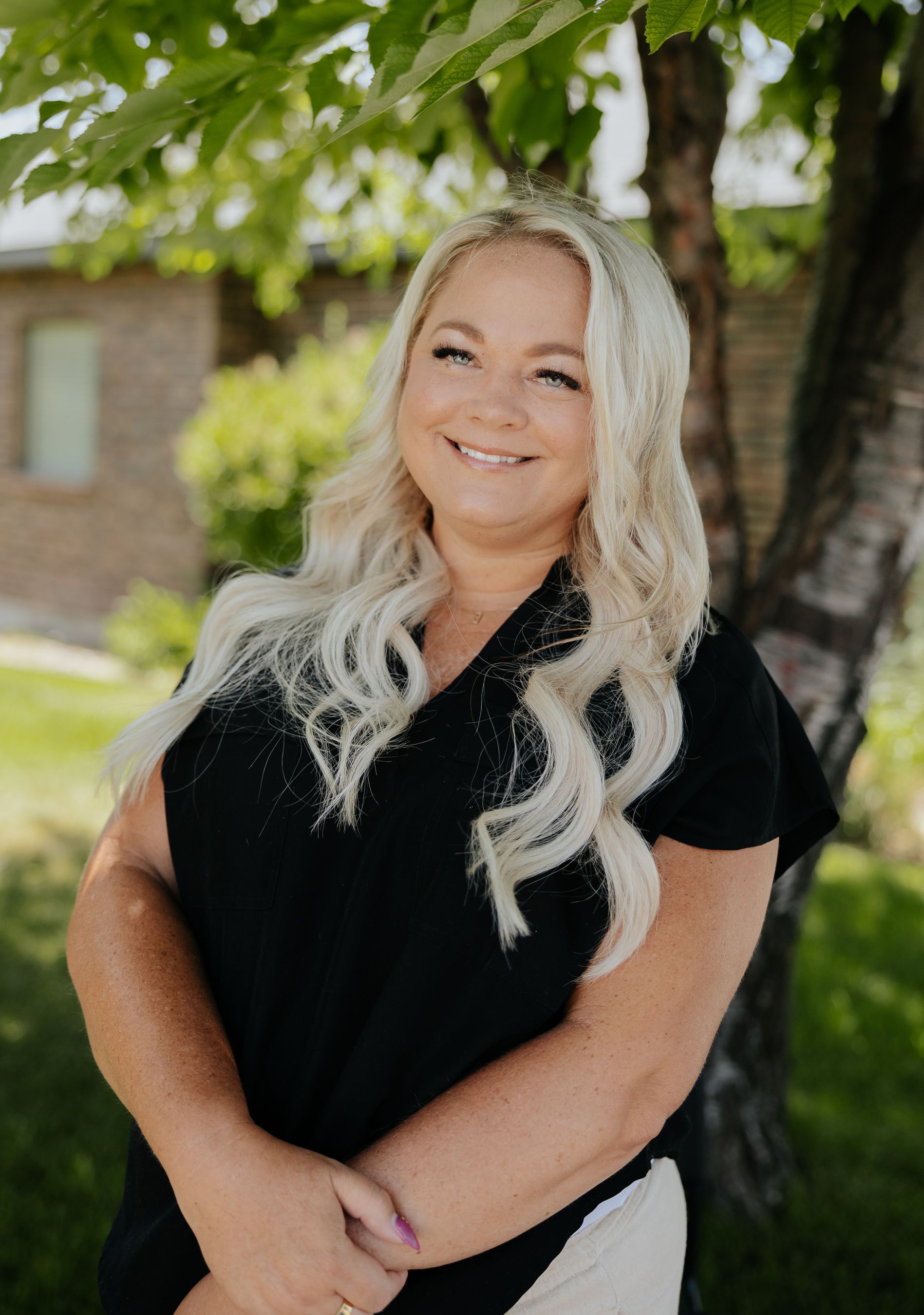 A woman with blonde hair is smiling for the camera.