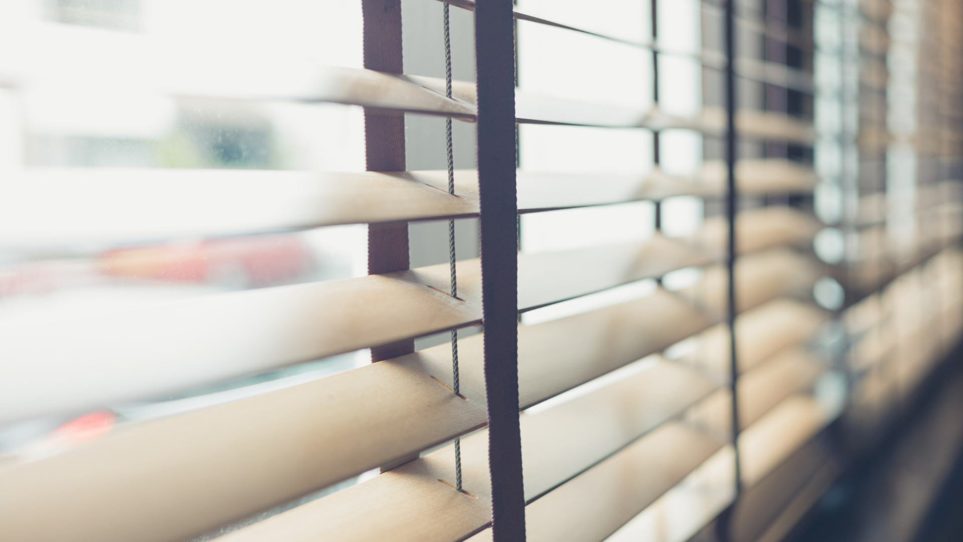 A close up of a window with blinds on it.
