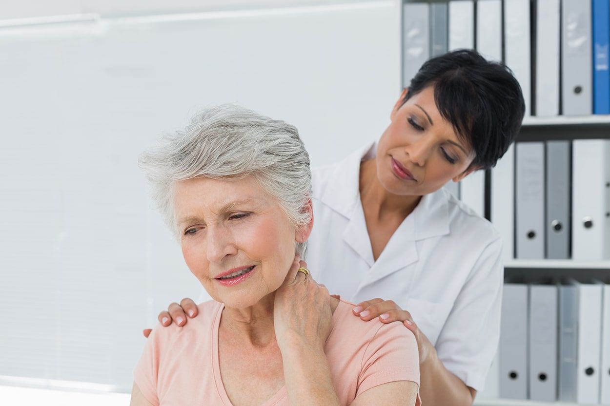 an older woman is discussing shoulder pain with a nurse