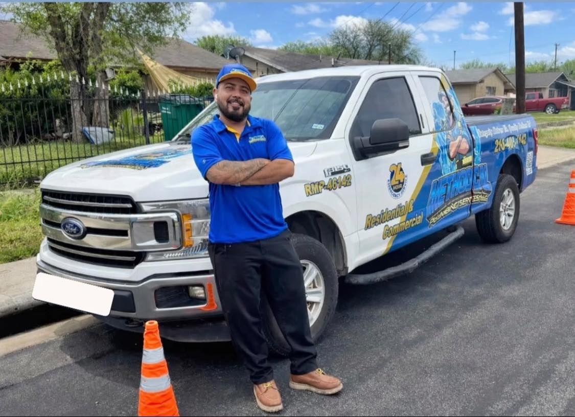 Van parked near a tent under a cloudy sky. Buildings and trees are in the background.