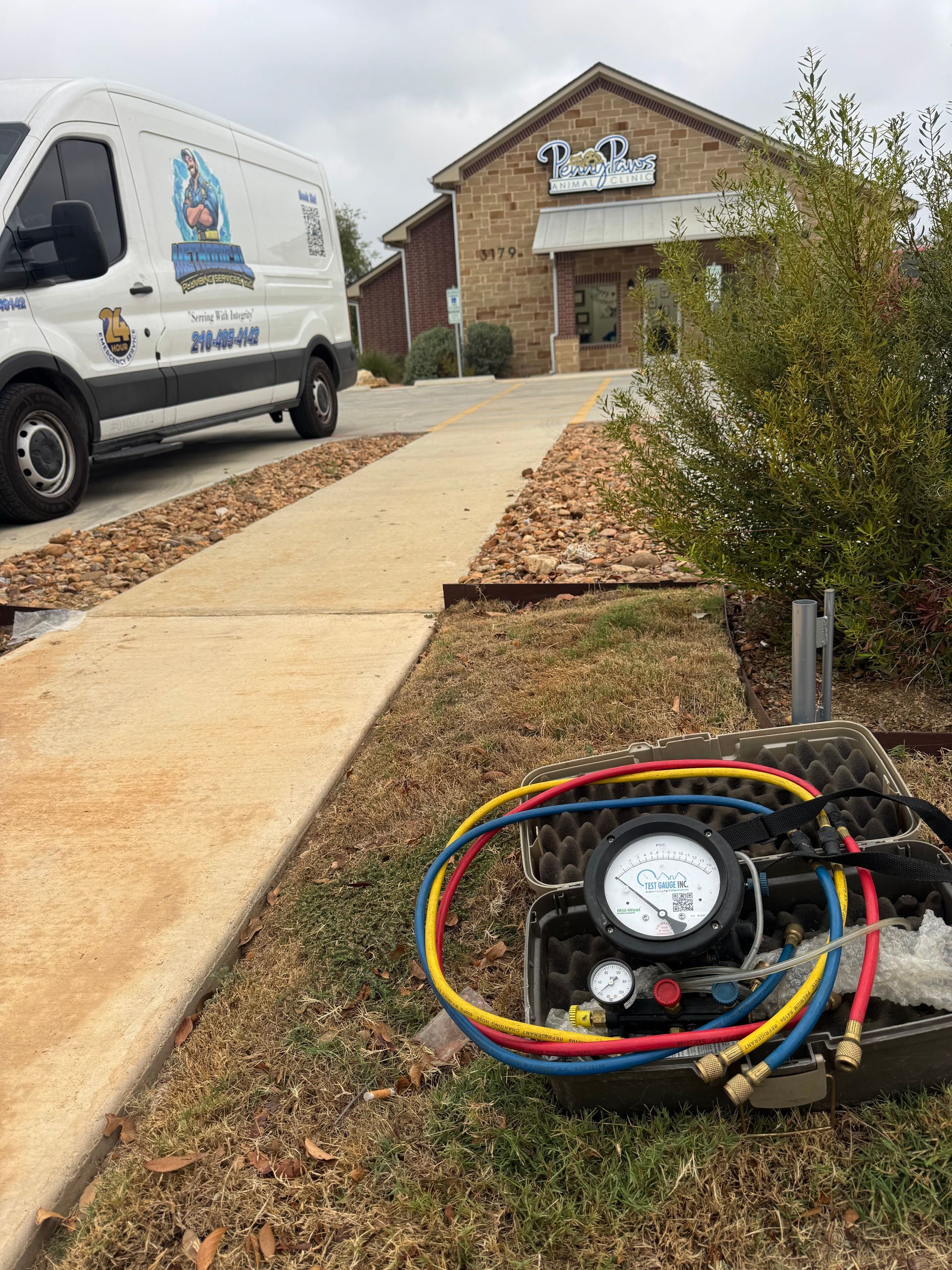 Red and green valves with pipes in a utility room setting.