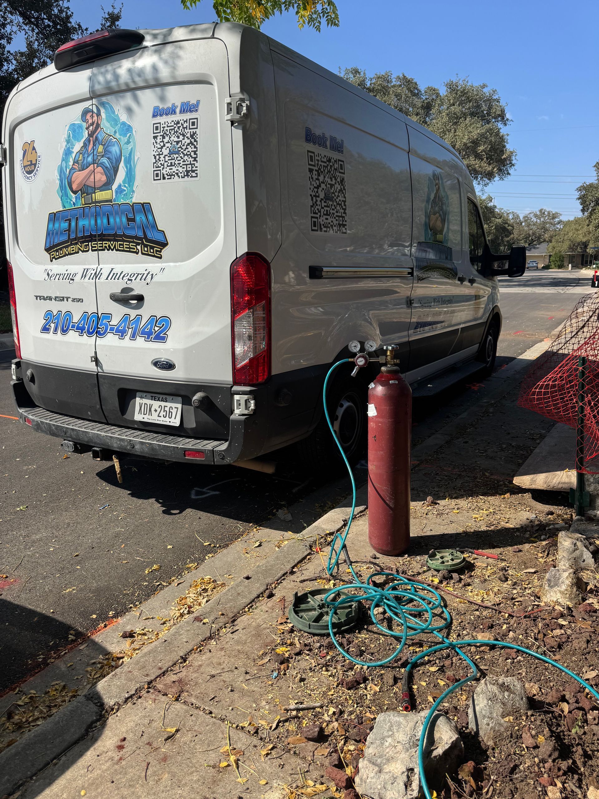 Red and green valves with pipes in a utility room setting.