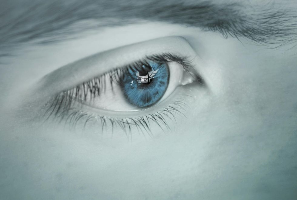 A close up of a person 's blue eye.