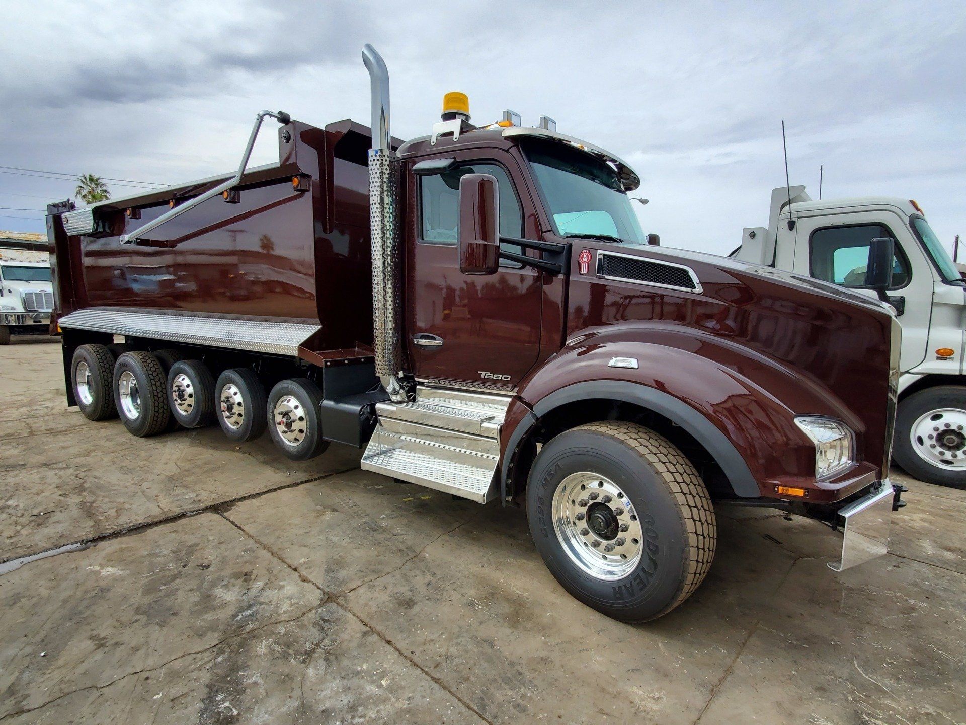 A brown dump truck is parked in a parking lot.