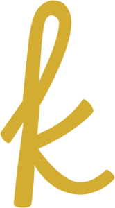 A gold letter k is on a white background.