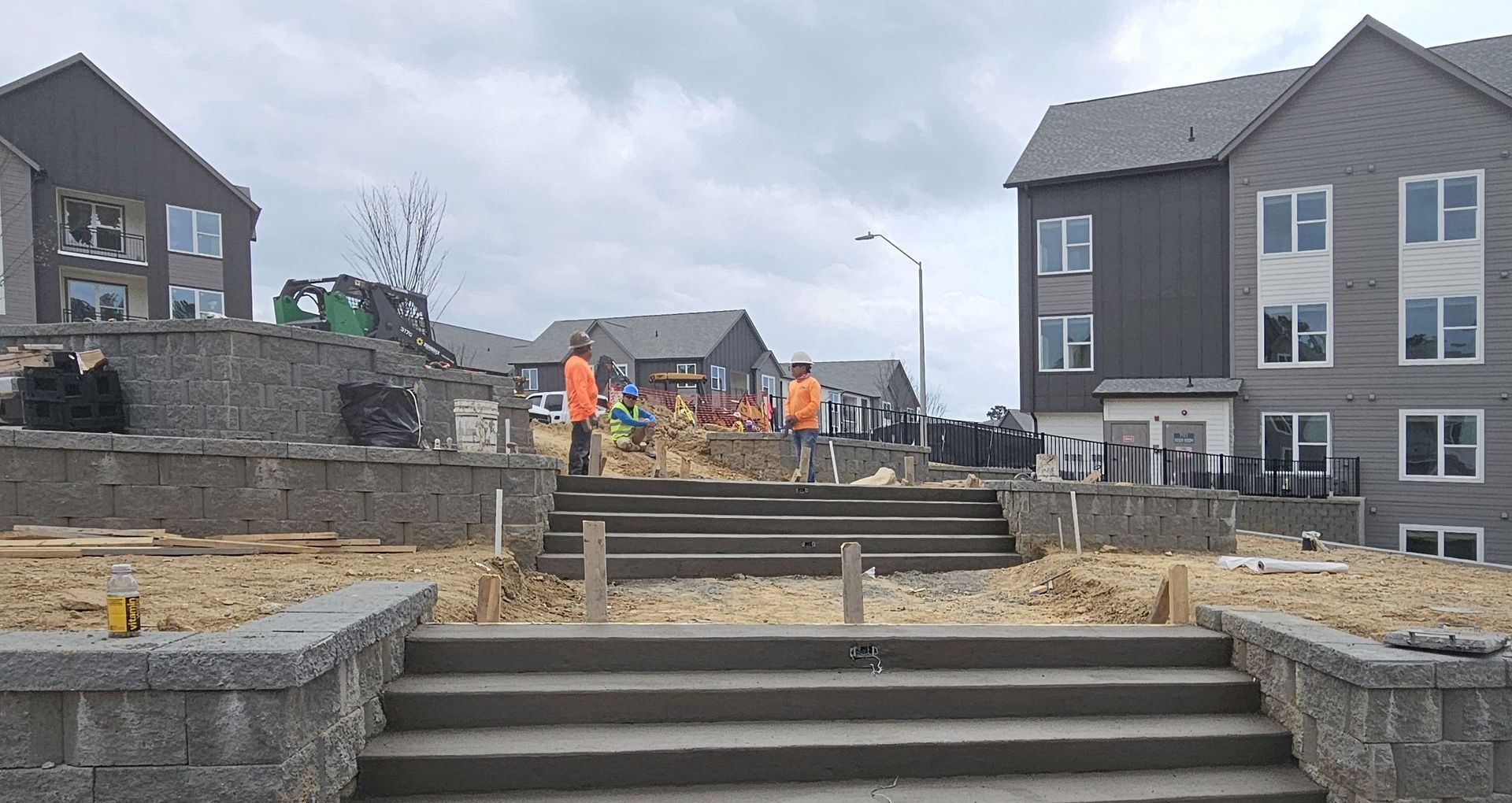 A group of people are standing in front of a building under construction.