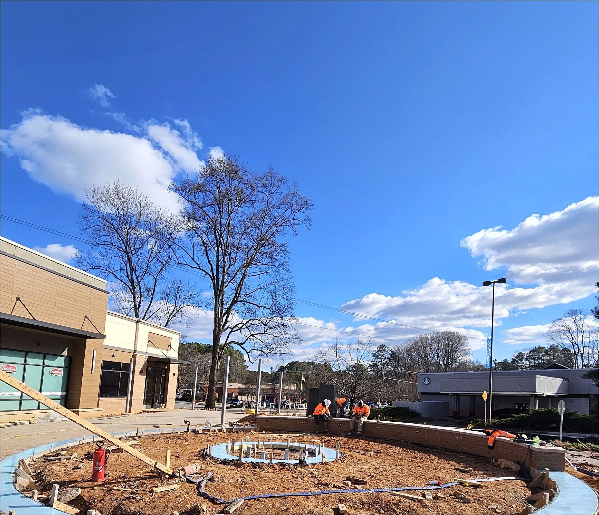 A circle of dirt is being built in front of a building