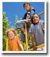 Three Kids on a Playground — St. Avenel, NJ — Pumpkin Patch Child Care Centers