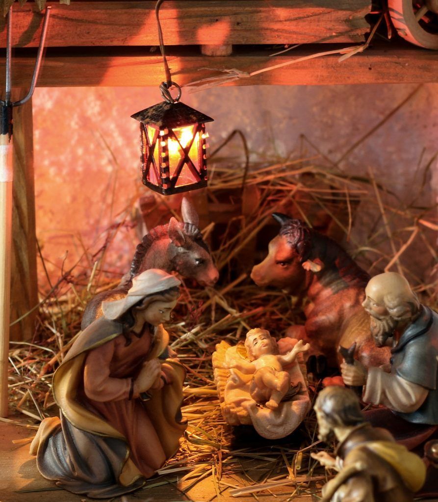 A nativity scene with a lantern hanging from the ceiling