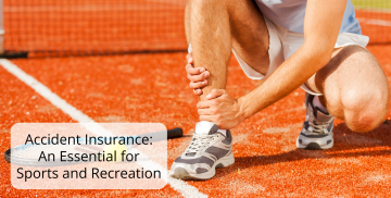 A person is kneeling down on a tennis court holding their ankle.