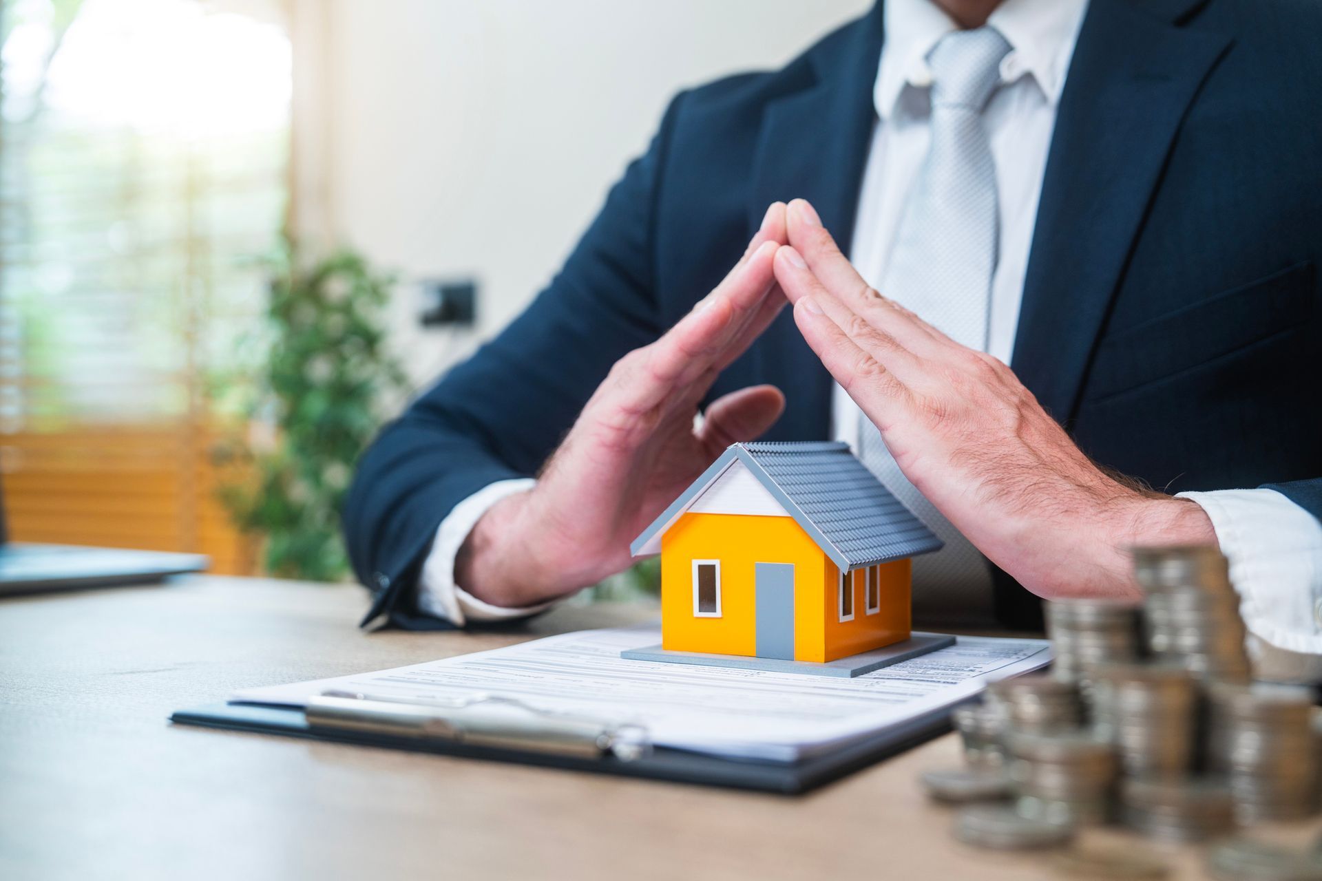 A line icon of a person in a circle surrounded by houses.