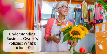 A woman is holding a bouquet of sunflowers in a flower shop.