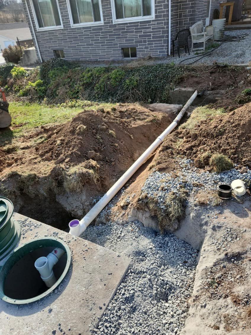 A septic tank is being installed in the backyard of a house.