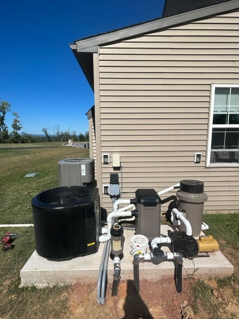 A house with a lot of pipes in front of it.