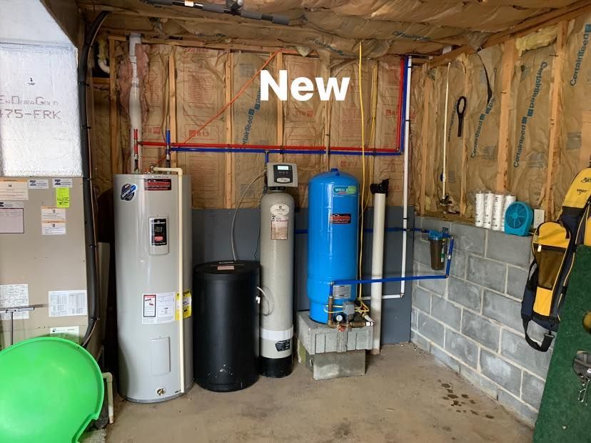 A pool pump is sitting on top of a pile of dirt next to a house.