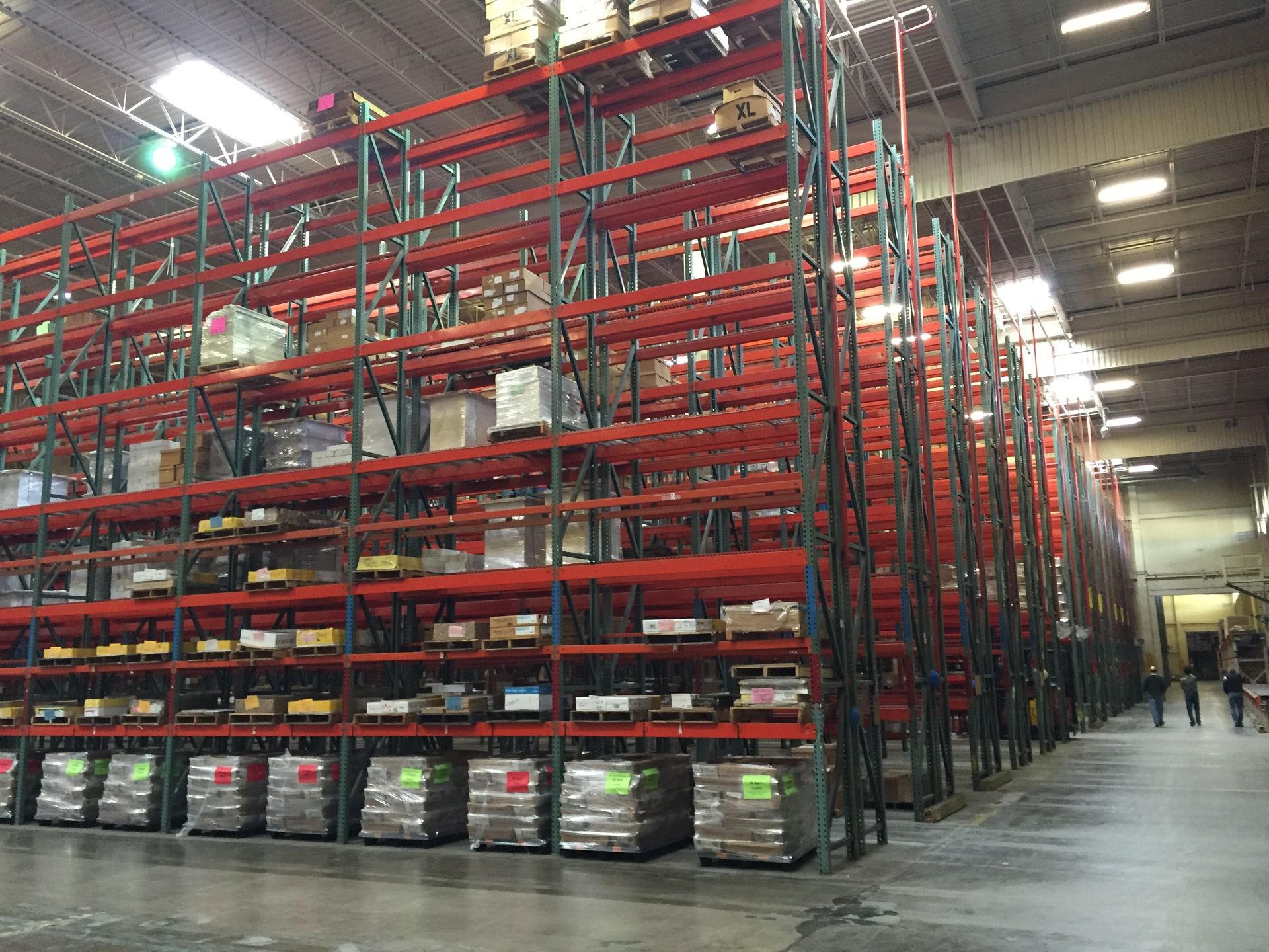 A large warehouse filled with lots of shelves and pallets