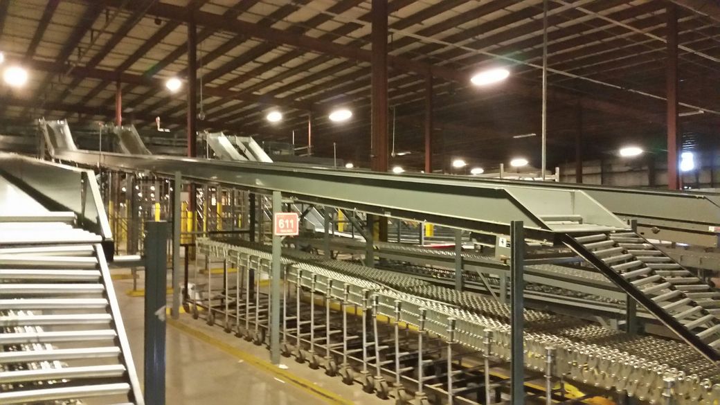 A large warehouse filled with lots of shelves and pallets