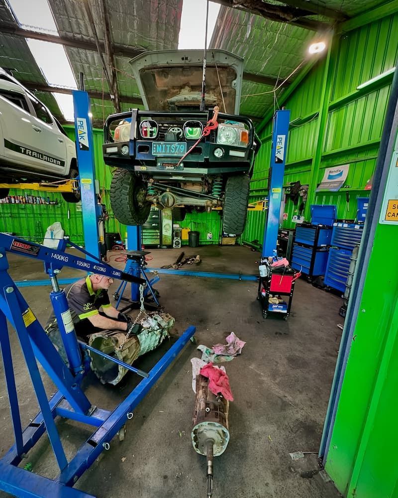 Mechanic Working on a Car Raised on a Lift in a Garage — Nova Auto Innovations in Belmont, NSW