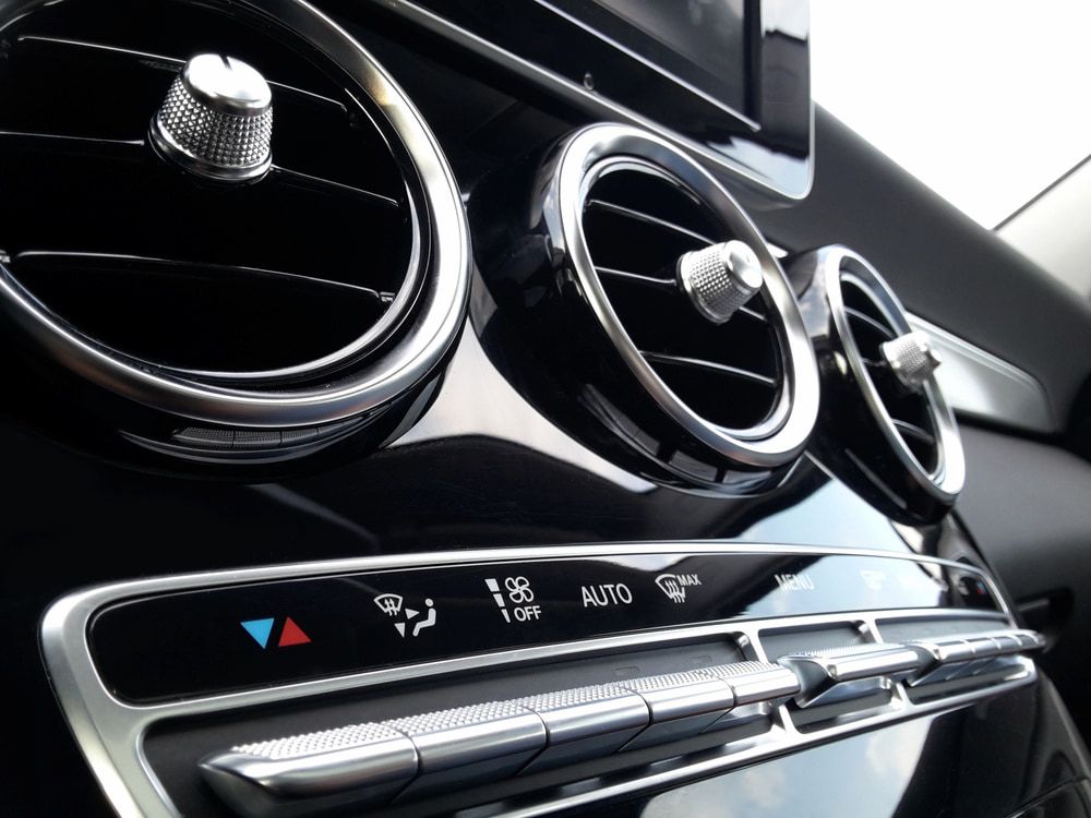 A Car's Black Dashboard With Silver Air Vents and Climate Control Buttons — Nova Auto Innovations in Charlestown, NSW