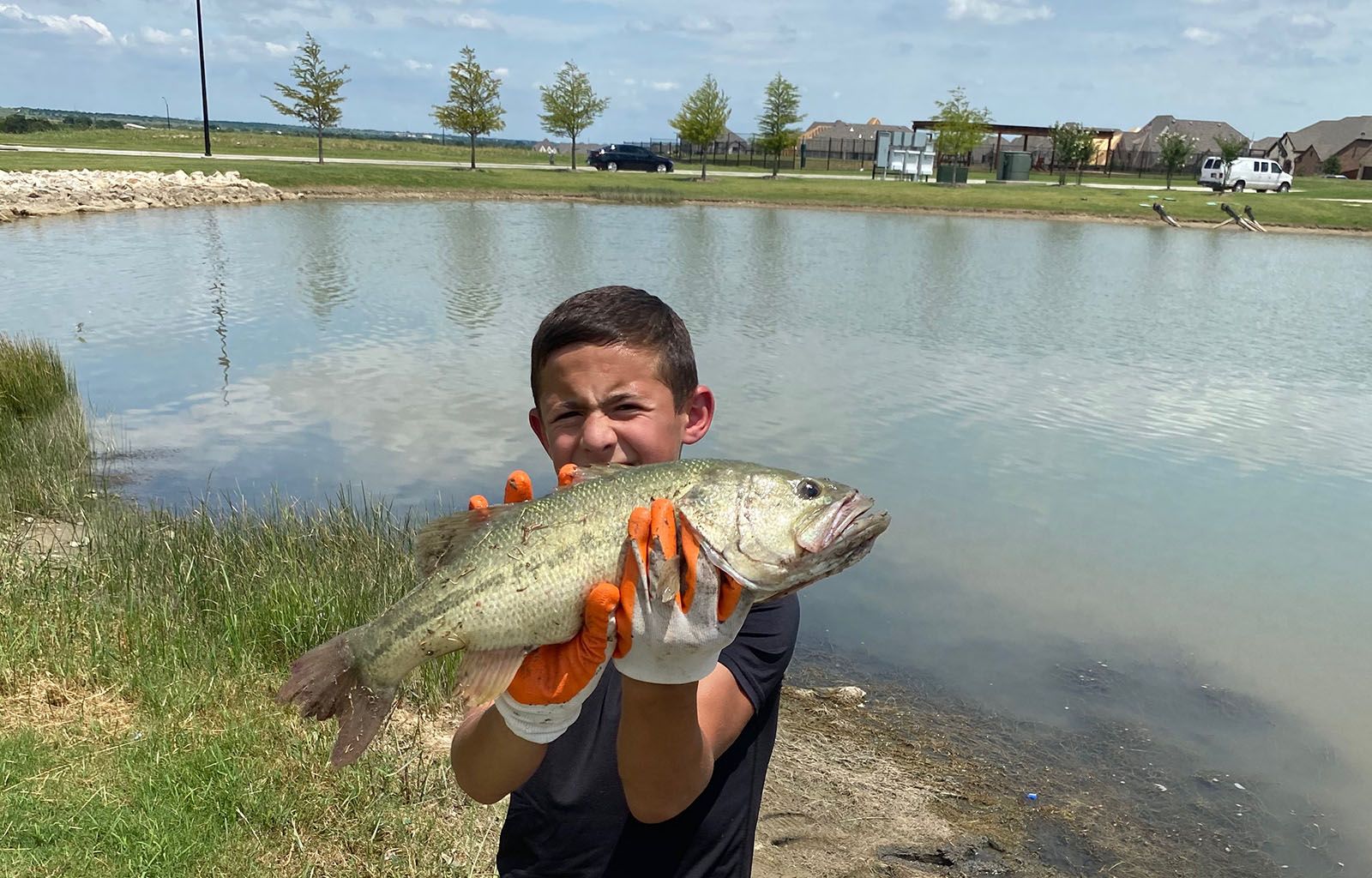 Child Holding a Large Fish | Morningstar Homes