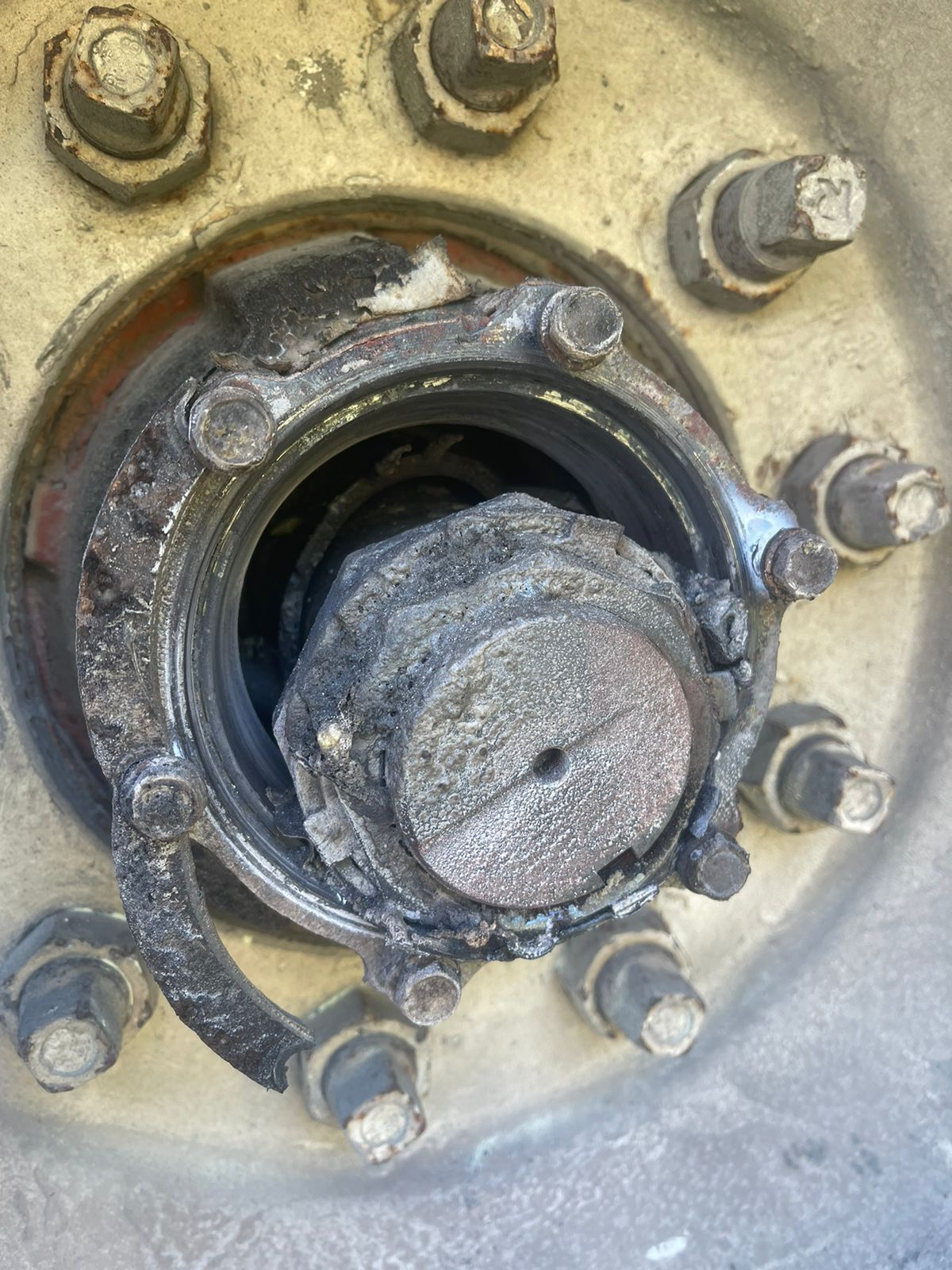 A close up of a rusty wheel hub on a truck.