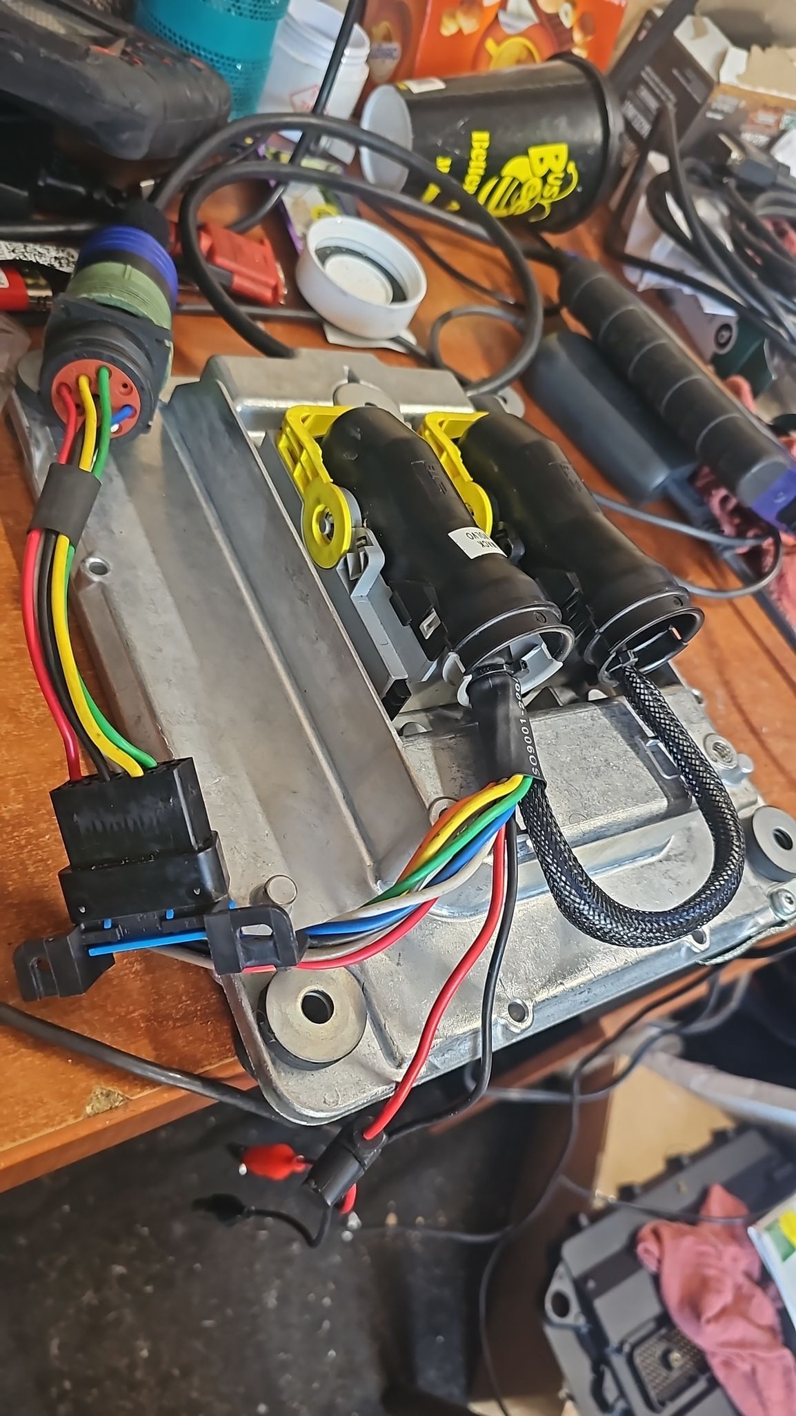 A bunch of wires are sitting on top of a wooden table.