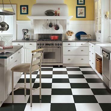 Carpet Installation — Kitchen With Checkered Black And White Tiles in Ypsilanti, MI