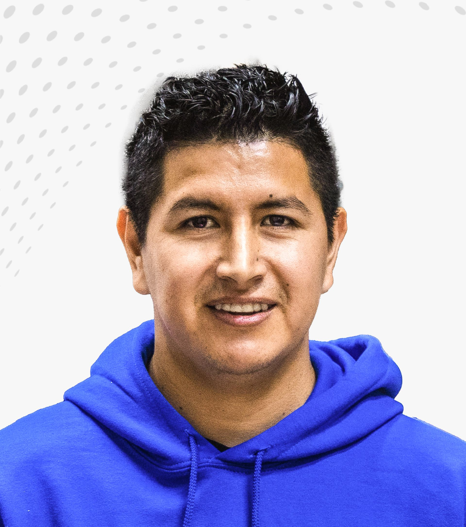 Smiling person in a bright blue hoodie against a light patterned background