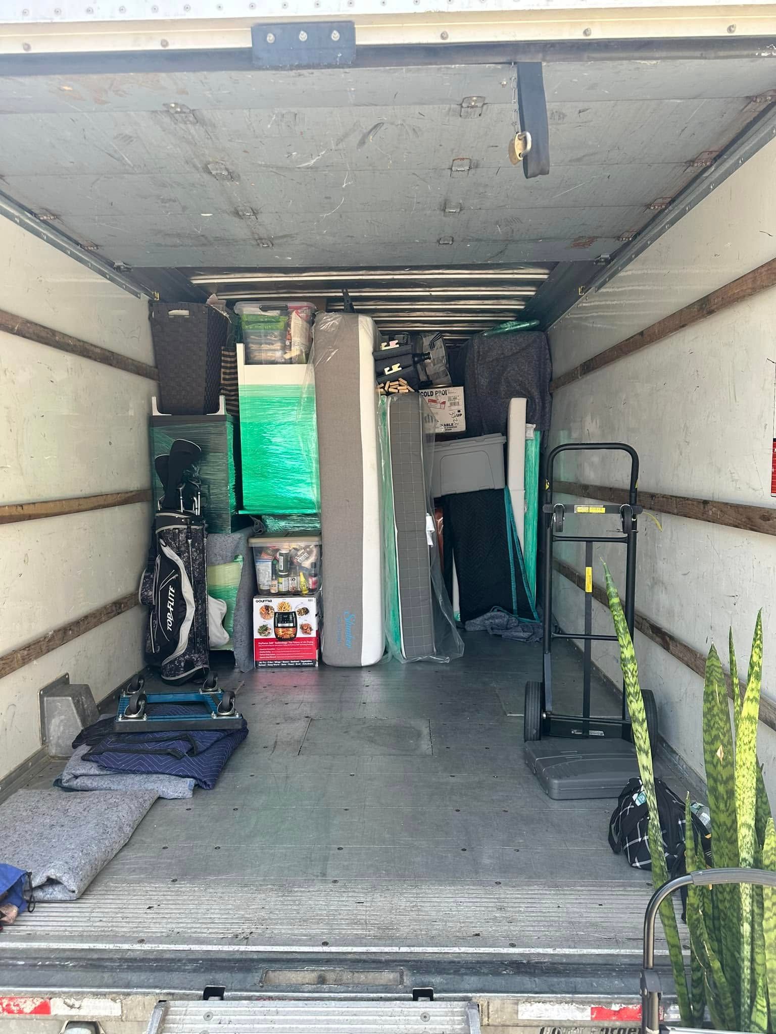 Inside of a moving truck filled with various household items.