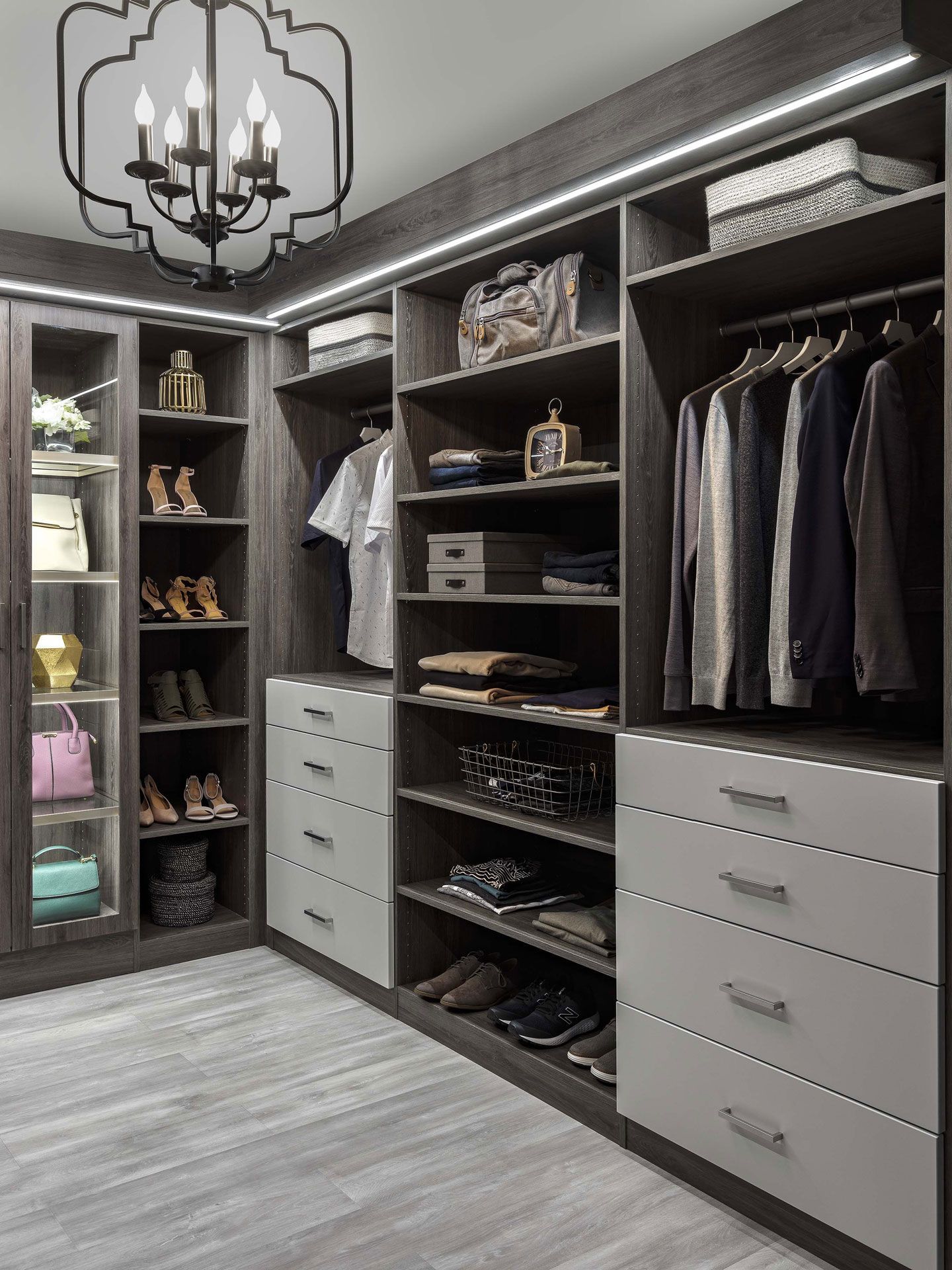 a walk in closet filled with lots of clothes and shoes .