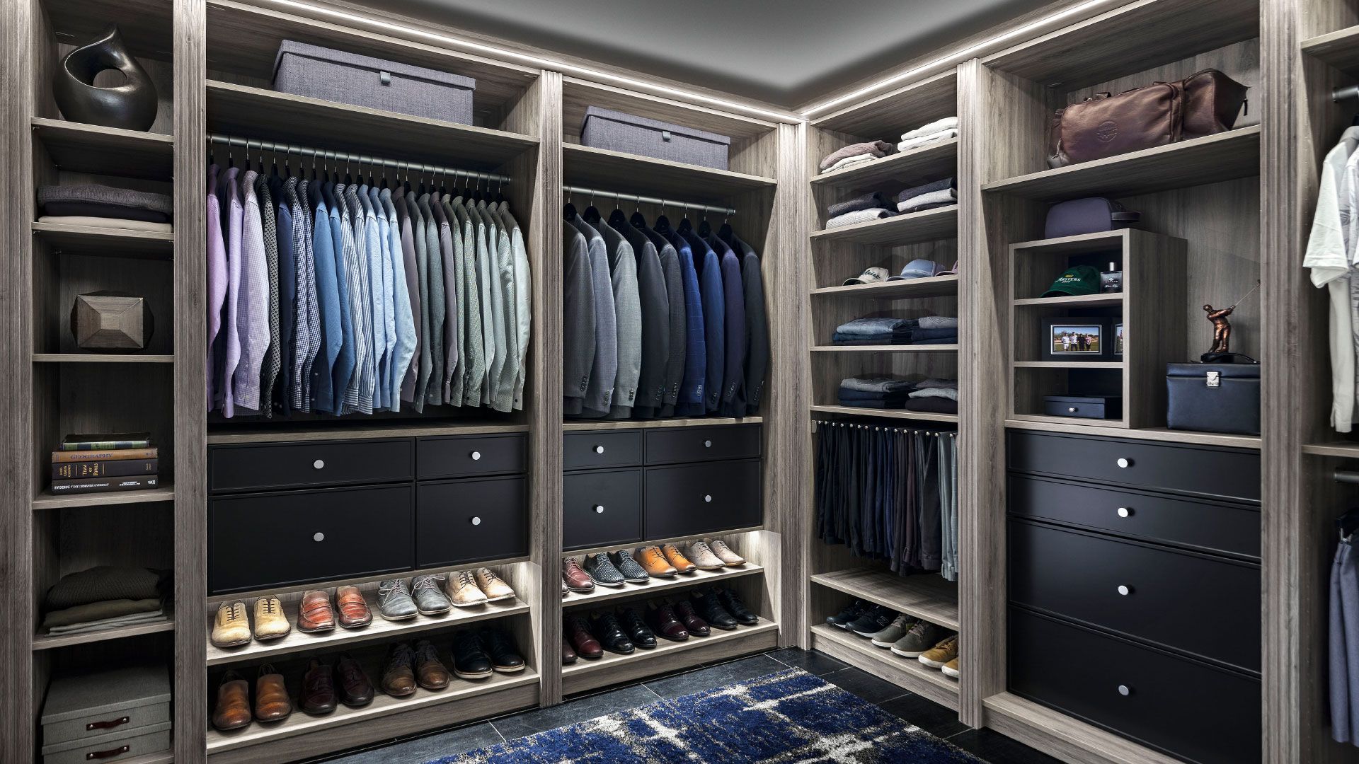 a walk in closet filled with lots of clothes and shoes .