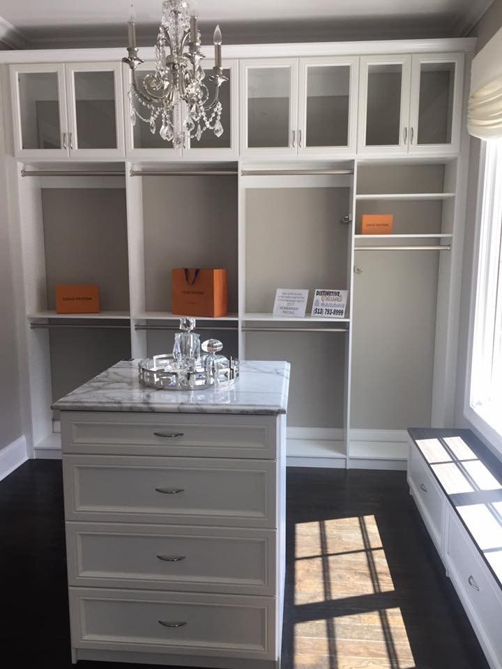 A walk in closet with a large island in the middle