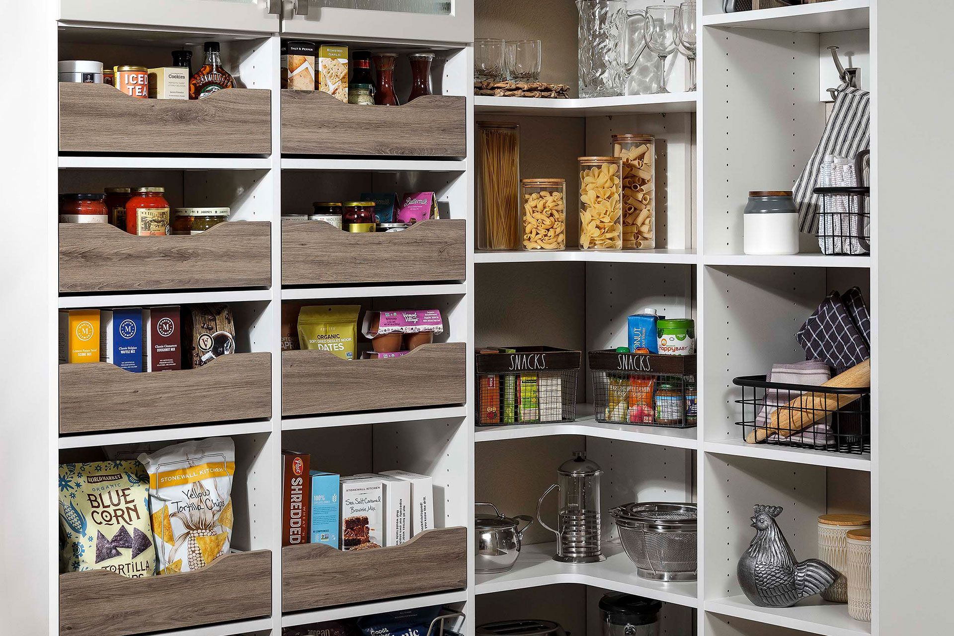 a pantry filled with lots of food and utensils .