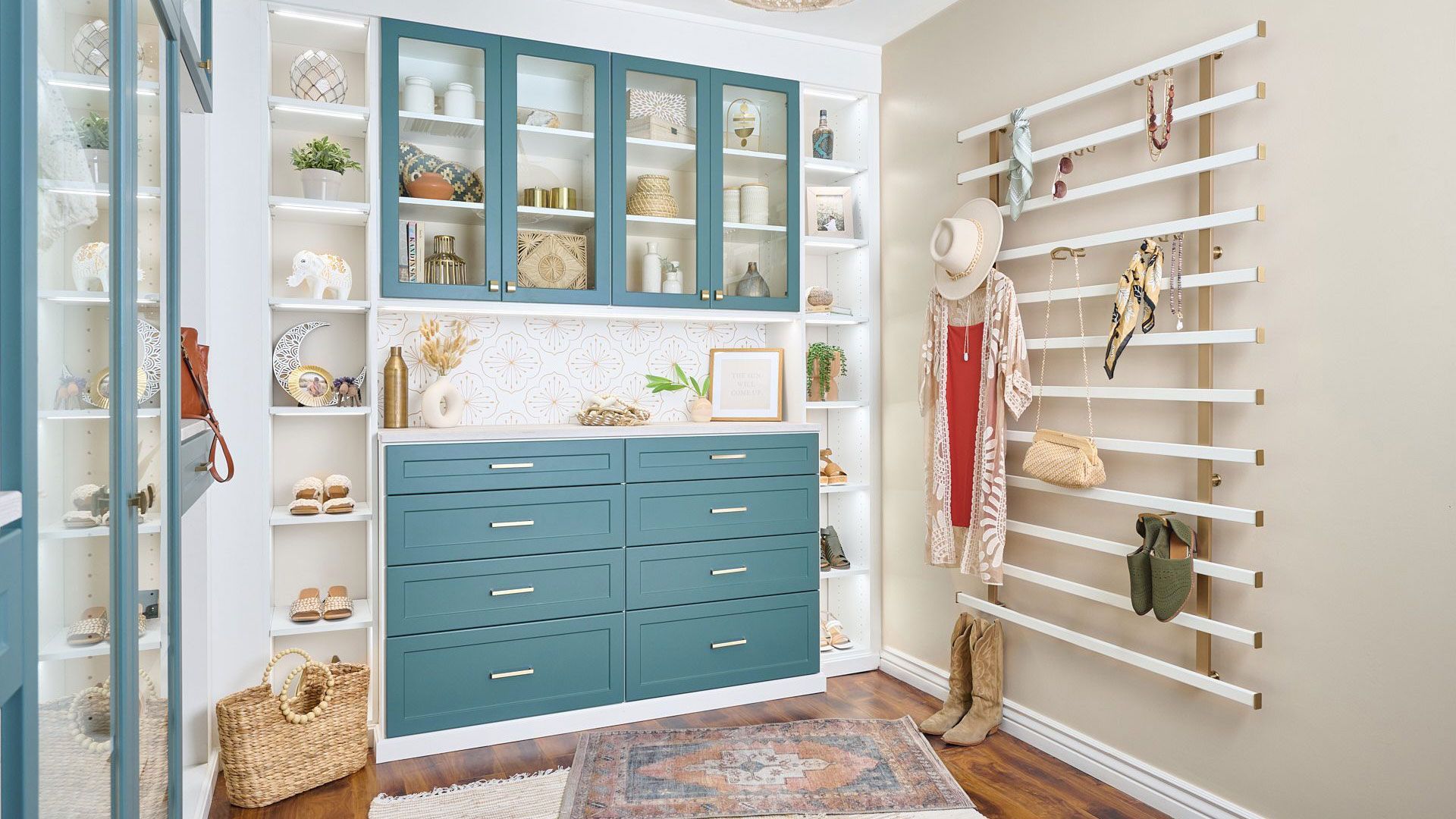 a walk in closet with blue cabinets and white shelves .