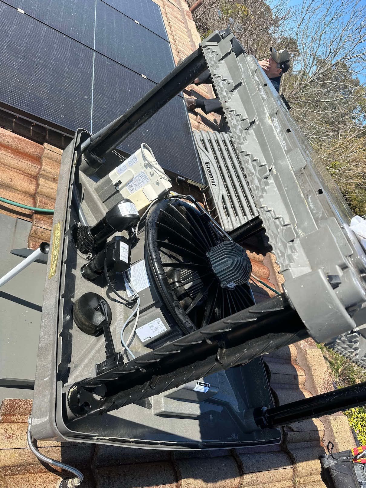 A satellite dish is sitting on top of a brick roof.