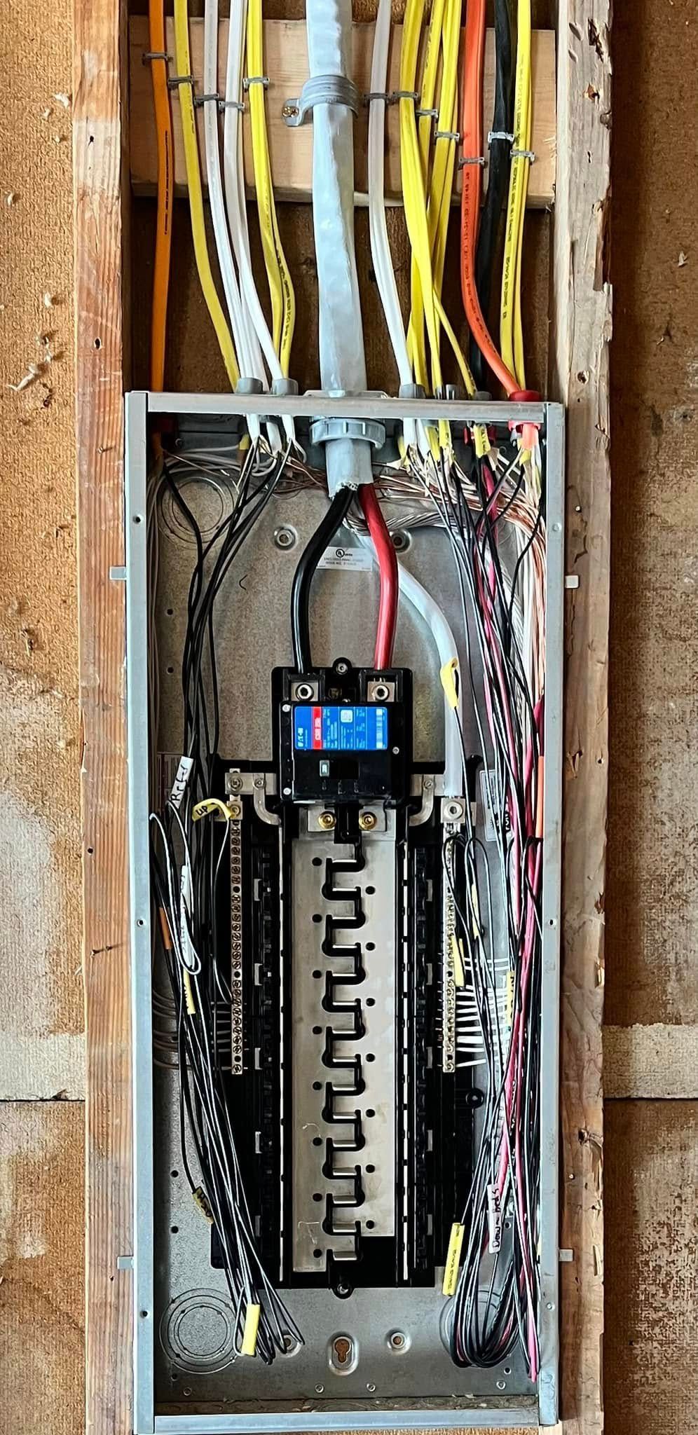 A close up of an electrical box with wires coming out of it.