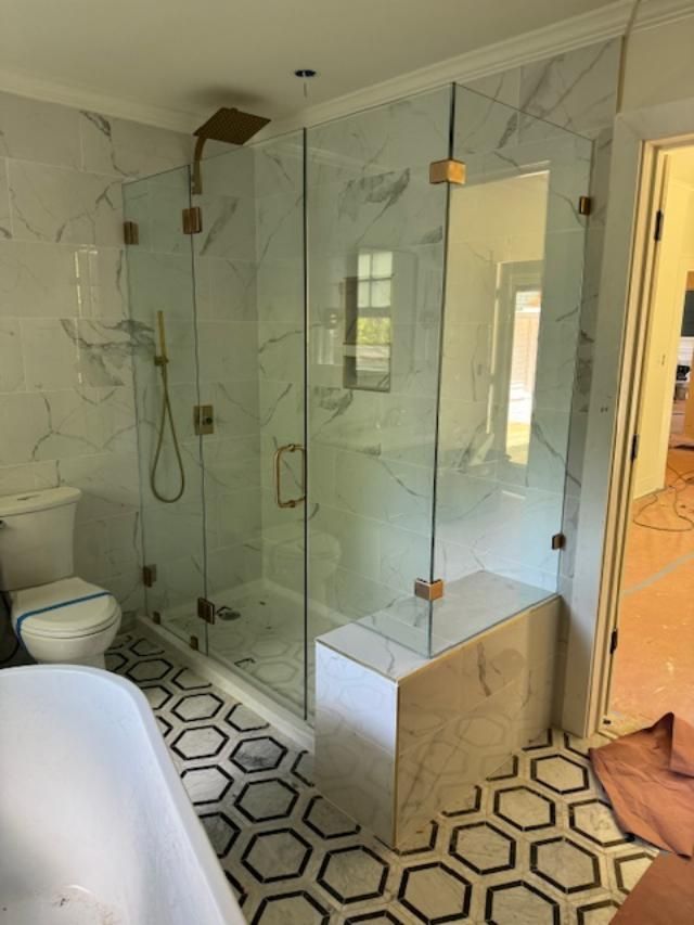 A bathroom with a walk in shower and a bathtub.