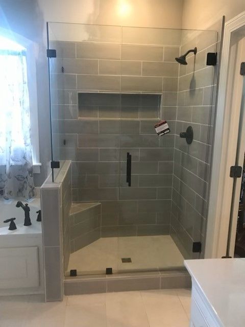 A bathroom with a walk in shower and a bathtub.