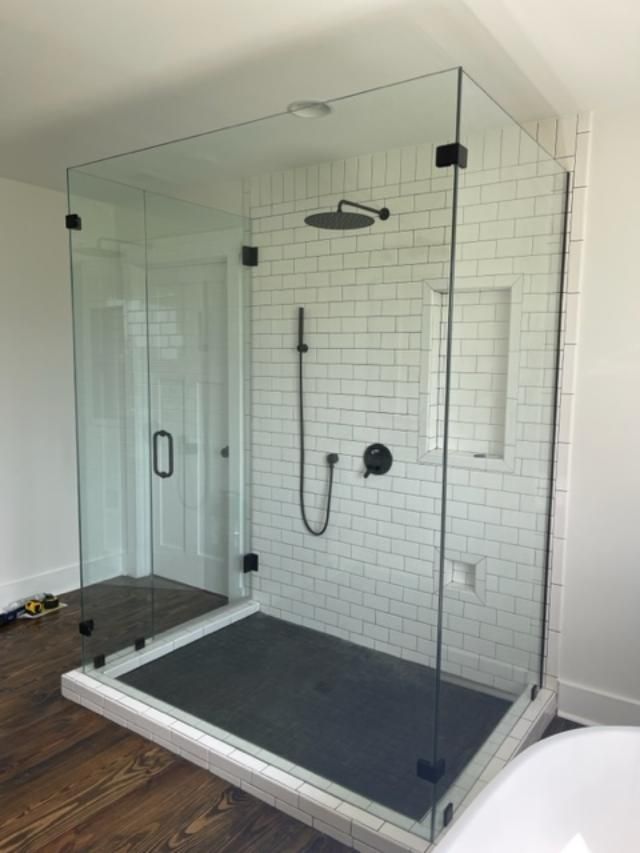 A bathroom with a walk in shower and a bathtub.