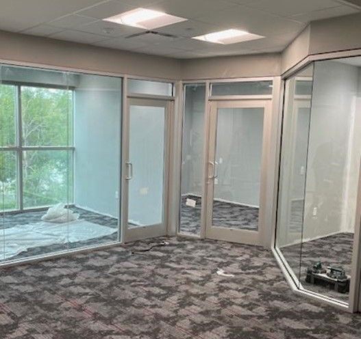 An empty room with a lot of windows and doors.