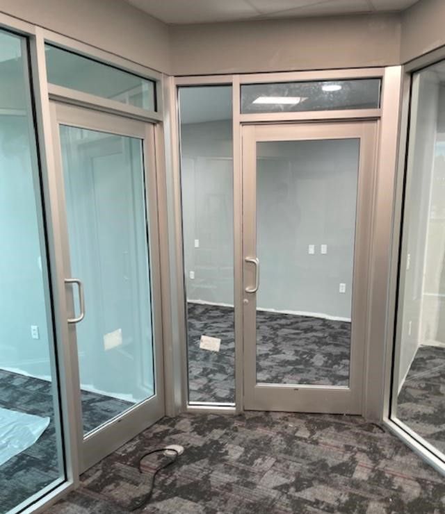 A room with a lot of windows and a door.