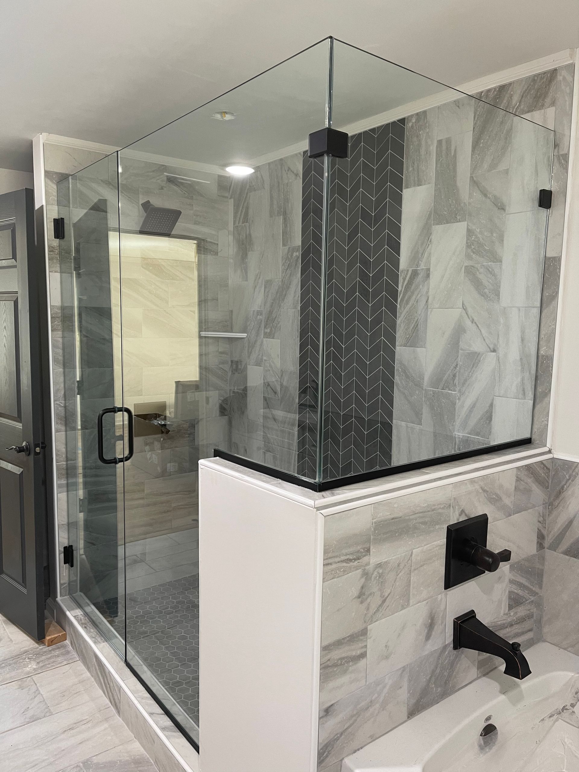 A bathroom with a walk in shower and a bathtub.