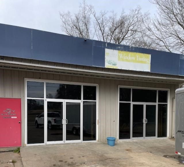 A building with a sign that says window tinting on it