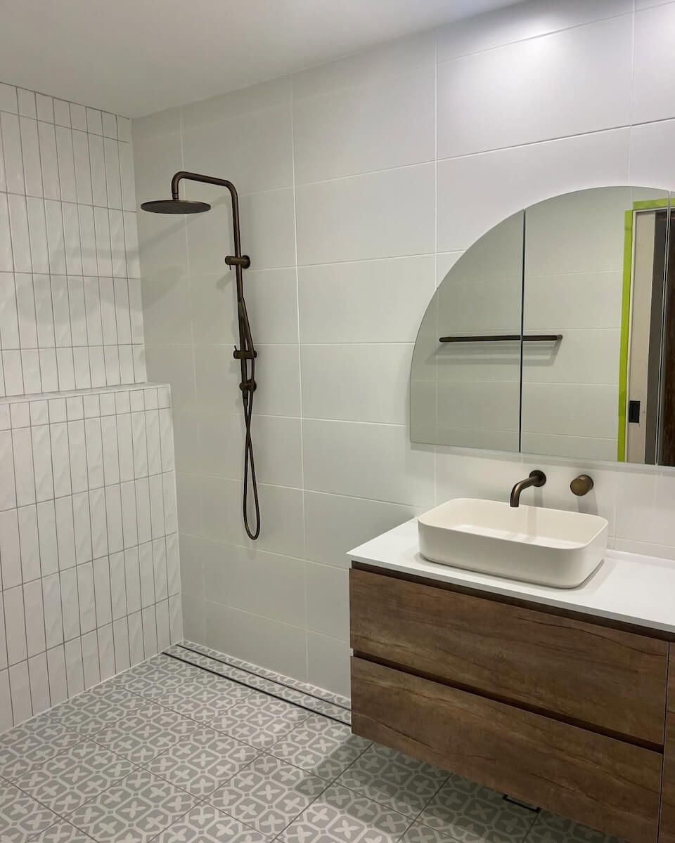 A bathroom with a sink , shower and mirror — JMJ Plumbing & Drainage In Tumbi Umbi, NSW