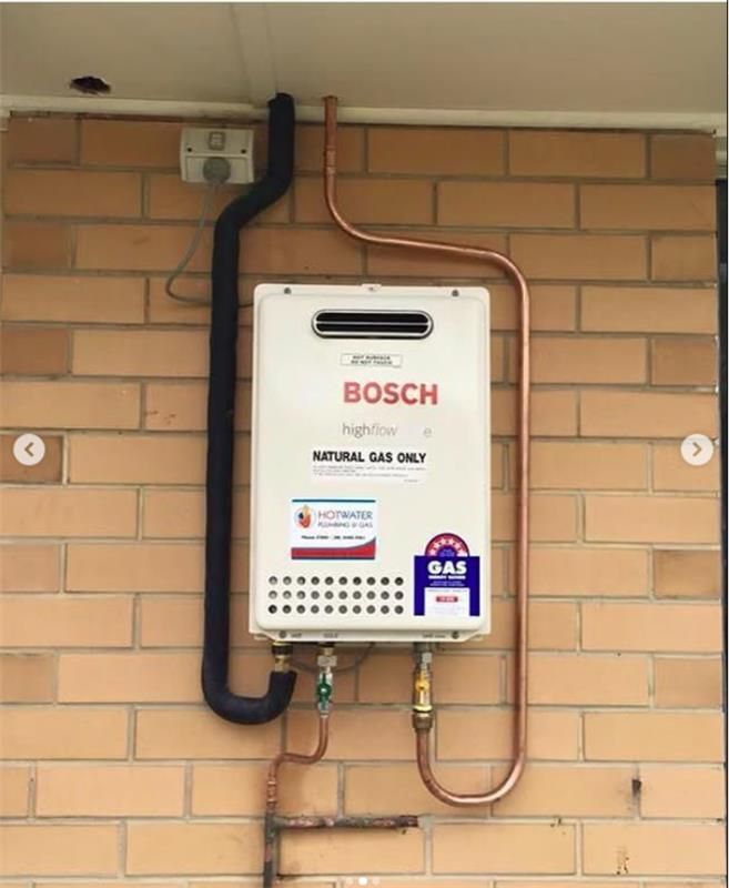 A gas system is attached to a brick wall — JMJ Plumbing & Drainage In Tumbi Umbi, NSW