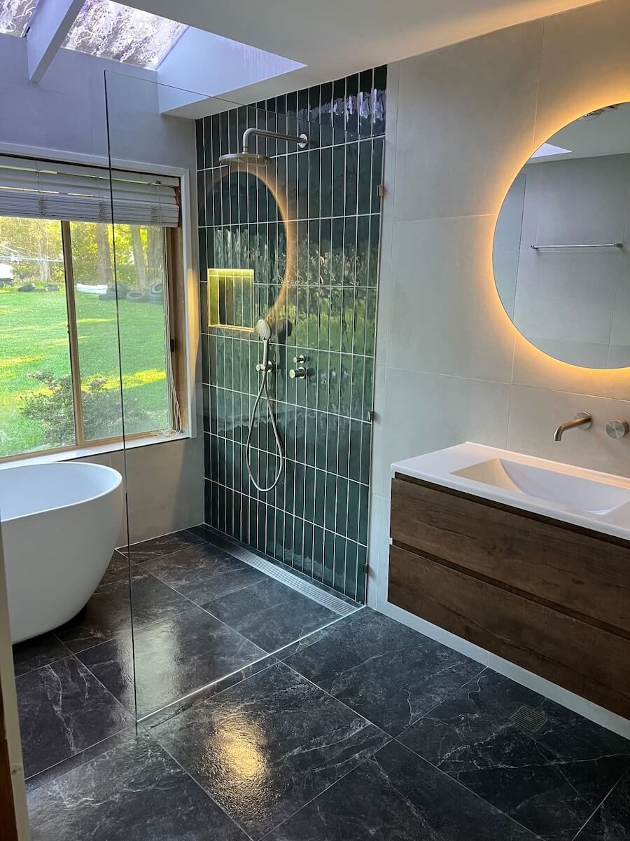A bathroom with a tub , sink , mirror and shower — JMJ Plumbing & Drainage In Tumbi Umbi, NSW