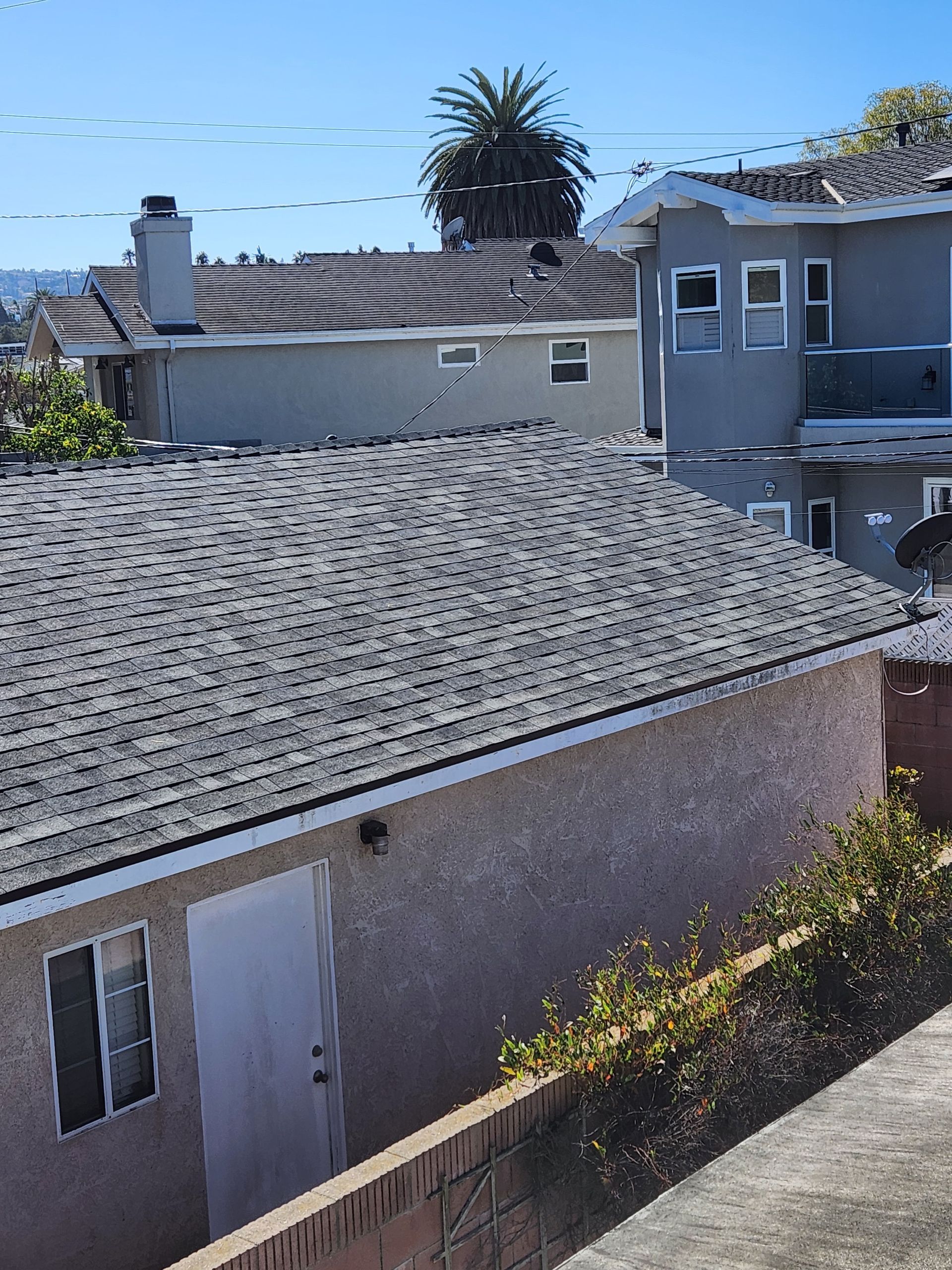 A house with a gray roof and a white door