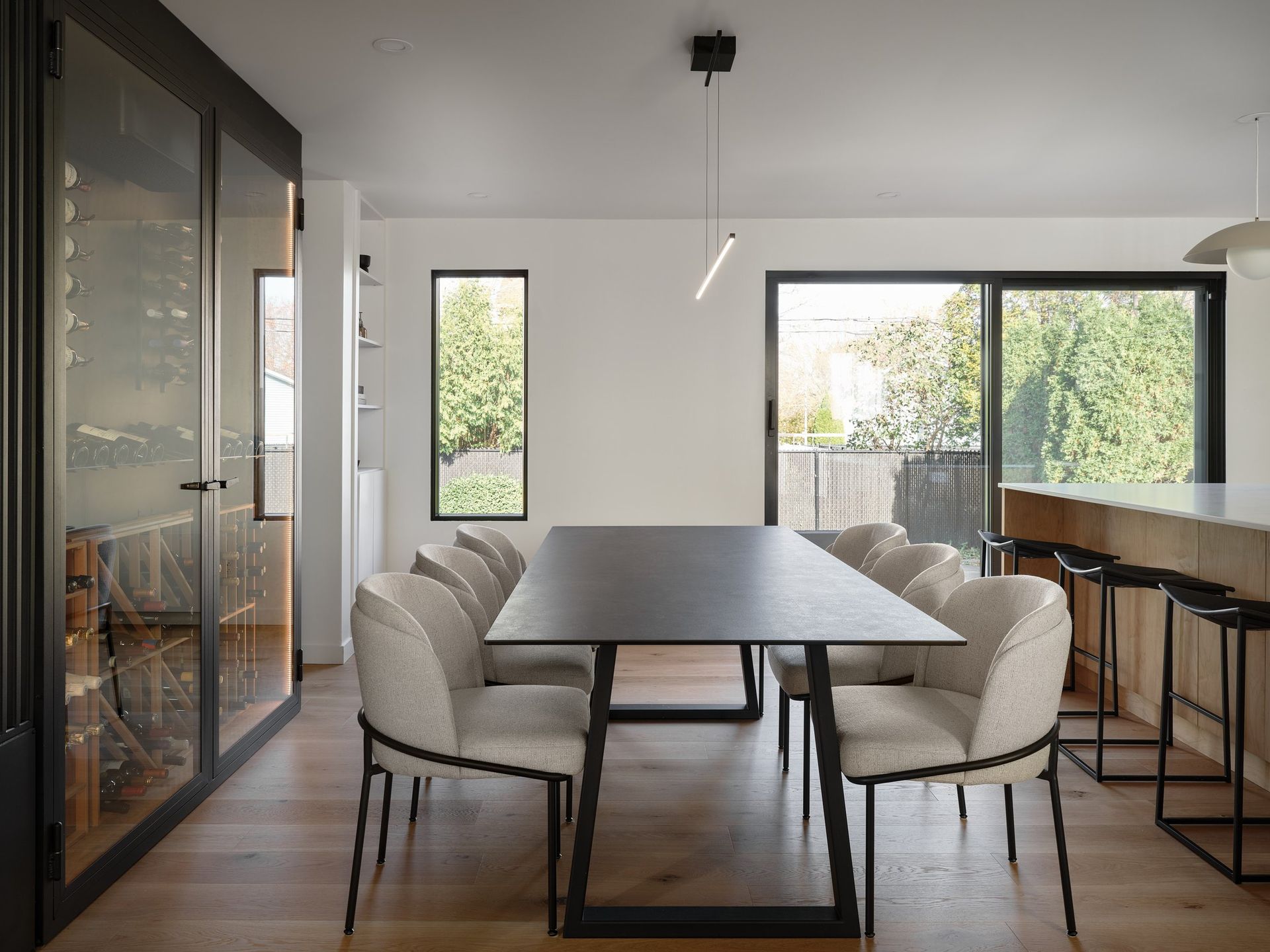 Une salle à manger avec une table et des chaises et une porte coulissante vitrée.